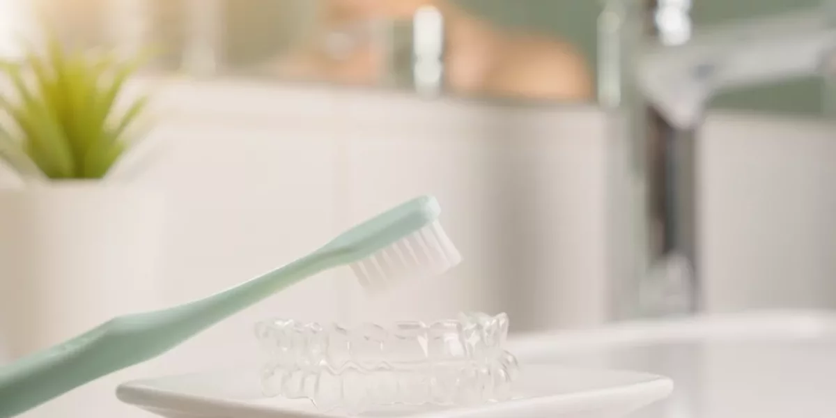 What retention keeps Invisalign results stable?